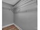 A simple gray closet with a hanging rack offers storage for clothes at 6208 Karenstone Dr, Charlotte, NC 28215