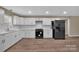Well-equipped kitchen featuring white cabinets, sleek appliances, and ample counter space at 6208 Karenstone Dr, Charlotte, NC 28215