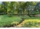 A peaceful backyard featuring a stream and lush greenery at 6515 Santa Cruz Trl, Charlotte, NC 28227