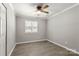 Neat bedroom with neutral paint, modern ceiling fan, and natural light from window at 6515 Santa Cruz Trl, Charlotte, NC 28227