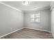 Bright, neutral bedroom with modern flooring, paint, and large window for natural light at 6515 Santa Cruz Trl, Charlotte, NC 28227