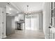 Dining area featuring new floors, modern lighting and access to the backyard at 6515 Santa Cruz Trl, Charlotte, NC 28227