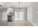 Dining area features new floors, modern lighting and access to the backyard at 6515 Santa Cruz Trl, Charlotte, NC 28227