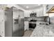 Spacious kitchen featuring stainless steel appliances, granite countertops, and ample cabinet space at 6515 Santa Cruz Trl, Charlotte, NC 28227