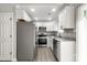 Kitchen features stainless steel appliances, granite countertops, new floors and white cabinets at 6515 Santa Cruz Trl, Charlotte, NC 28227