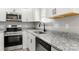Well-lit kitchen with stainless steel appliances, granite countertops, and white cabinetry at 6515 Santa Cruz Trl, Charlotte, NC 28227