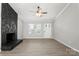 Bright living room features a ceiling fan, new floors and a stone fireplace at 6515 Santa Cruz Trl, Charlotte, NC 28227