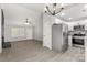 Open living room with fireplace, ample natural light, and adjacent modern kitchen at 6515 Santa Cruz Trl, Charlotte, NC 28227