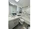 Renovated bathroom with modern vanity, blue and white marble style tile, and a shower-tub combo at 6517 Helens Way, Denver, NC 28037