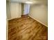 A bright bedroom features laminate flooring, freshly painted walls, and two closets at 6517 Helens Way, Denver, NC 28037