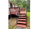 Red-stained deck with black railings and steps that provide access to the backyard at 6517 Helens Way, Denver, NC 28037