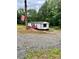 View of home on a gravel drive, featuring an American flag, ramp, metal roof and white siding at 6517 Helens Way, Denver, NC 28037