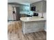 This kitchen features stainless appliances, stone countertops, and modern cabinets with a bar top at 6517 Helens Way, Denver, NC 28037
