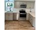 Bright kitchen features stone countertops, stainless appliances, and modern light grey cabinetry at 6517 Helens Way, Denver, NC 28037