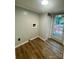 Bright laundry room features wood-look flooring, utility connections, and a door to the outside at 6517 Helens Way, Denver, NC 28037