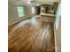Open concept living room and kitchen area feature laminate floors and recessed lighting at 6517 Helens Way, Denver, NC 28037