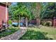 Lush backyard featuring a pool, stone pathway, and mature trees at 7014 Walton Heath Ln, Charlotte, NC 28277