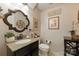 Powder room with granite countertop, decorative mirror, and elegant fixtures at 7014 Walton Heath Ln, Charlotte, NC 28277