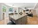 Open floor plan with kitchen island looking into the dining area and fireplace in the living room at 7014 Walton Heath Ln, Charlotte, NC 28277