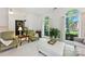 Cozy living room with large windows, comfortable seating, and elegant decor at 7014 Walton Heath Ln, Charlotte, NC 28277