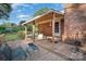 A wood-floored back porch with outdoor chairs, a brick exterior, and a wooden awning with a view of the backyard at 753 Briarfield Rd, Rock Hill, SC 29730