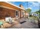 A wood-floored covered back porch with outdoor chairs, a brick exterior, and a view of the backyard at 753 Briarfield Rd, Rock Hill, SC 29730