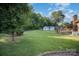 A spacious backyard with trees, a lawn, a shed, a wooden porch, and a brick exterior at 753 Briarfield Rd, Rock Hill, SC 29730