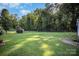 A spacious backyard with trees, a gazebo, and a shed, surrounded by a lush green lawn at 753 Briarfield Rd, Rock Hill, SC 29730