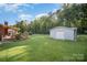View of the backyard with a detached garage and brick exterior porch surrounded by a lush green lawn at 753 Briarfield Rd, Rock Hill, SC 29730