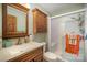 Well-maintained bathroom featuring wood cabinetry, essential fixtures, and a modern glass-enclosed shower at 753 Briarfield Rd, Rock Hill, SC 29730