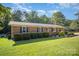 Well-maintained brick home, showcasing manicured front yard, mature trees and bright green lawn at 753 Briarfield Rd, Rock Hill, SC 29730