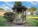 Outdoor wooden gazebo with built-in swing seating in a backyard surrounded by greenery and lawn at 753 Briarfield Rd, Rock Hill, SC 29730