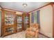 Sitting area featuring decorative display cabinets and a window with patterned glass at 753 Briarfield Rd, Rock Hill, SC 29730