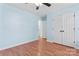 Bedroom with blue walls, hardwood flooring, a ceiling fan, and a closet at 8000 Pelorus Ln, Charlotte, NC 28269
