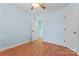 Bright bedroom features a ceiling fan, wood-look floors, and ample closet space at 8000 Pelorus Ln, Charlotte, NC 28269