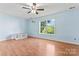 Bedroom with two windows, hardwood flooring, and a ceiling fan at 8000 Pelorus Ln, Charlotte, NC 28269
