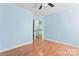 Bedroom with light blue walls and hardwood floors offers a relaxing atmosphere at 8000 Pelorus Ln, Charlotte, NC 28269