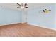 Bedroom with light blue walls, hardwood flooring, and a ceiling fan at 8000 Pelorus Ln, Charlotte, NC 28269