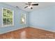 Spacious bedroom features ample natural light from the windows and a ceiling fan at 8000 Pelorus Ln, Charlotte, NC 28269
