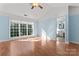 Bright bedroom features large window and ceiling fan providing ample natural light and ventilation at 8000 Pelorus Ln, Charlotte, NC 28269