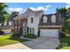 Charming brick and siding home featuring a well-manicured lawn and two-car garage at 8000 Pelorus Ln, Charlotte, NC 28269