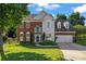 Charming brick and siding home featuring a well-manicured lawn and two-car garage at 8000 Pelorus Ln, Charlotte, NC 28269