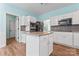 Kitchen featuring an island, granite counters, white cabinets, and stainless steel appliances at 8000 Pelorus Ln, Charlotte, NC 28269