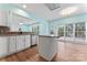 Kitchen featuring an island, stainless steel appliances, and a view to the patio at 8000 Pelorus Ln, Charlotte, NC 28269