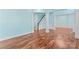 Spacious living room showcasing an open staircase and gleaming hardwood floors at 8000 Pelorus Ln, Charlotte, NC 28269