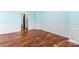 Empty room featuring hardwood floors and white wainscoting at 8000 Pelorus Ln, Charlotte, NC 28269
