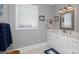 Bright bathroom with a white vanity, framed mirror, and window letting in plenty of natural light at 804 Creek Bluff Rd, Rock Hill, SC 29732