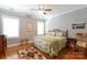 Sunlit bedroom with hardwood floors, floral bedding, neutral colored walls and two windows letting in natural light at 804 Creek Bluff Rd, Rock Hill, SC 29732