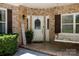 Inviting covered porch with swing, brick accents, and a welcoming entrance at 804 Creek Bluff Rd, Rock Hill, SC 29732