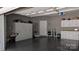 Spacious garage with epoxy flooring, white cabinetry, and ample storage at 804 Creek Bluff Rd, Rock Hill, SC 29732